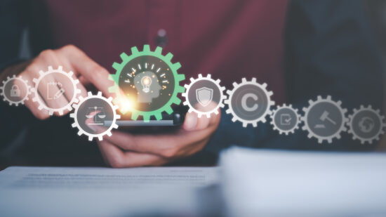 Businessman looking at data on smartphone, concept of copyright or intellectual property patent protection of copyright infringement proprietary declaration Legitimate innovations