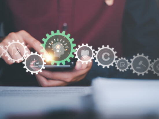 Businessman looking at data on smartphone, concept of copyright or intellectual property patent protection of copyright infringement proprietary declaration Legitimate innovations