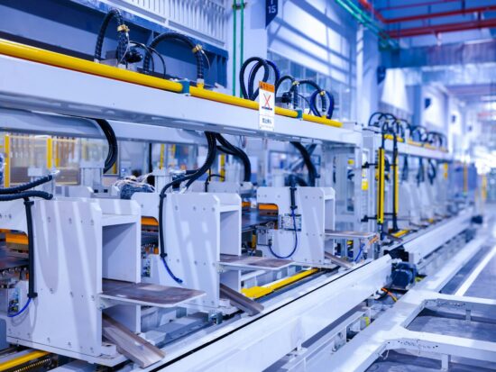 Industrial production line of a refrigerator manufacturing plant Translation: "WARNING Danger! Prohibit reach into"