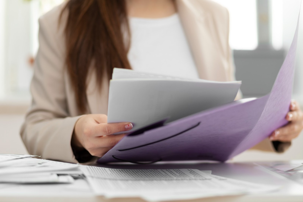 Legal professional reviewing documents from a folder