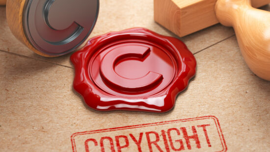 Copyright rubber stamp and sealing wax stamrp on the craft peper. Intellectual property and copyright concept.
