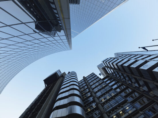 Directly below view of London city skyscrapers at dusk