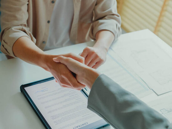 Close-up of Asian tenants sign house agreements on tablet and give them to female real estate agent after showing new houses. Landlord selling real estate to customers for investment.