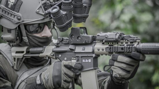 Military man, army, soldier in tactical uniform with carbine and tactical gloves.