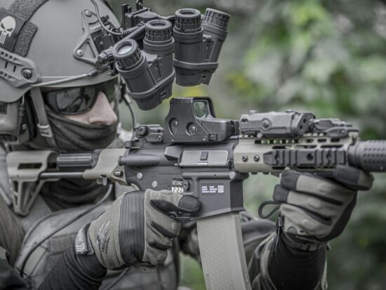 Military man, army, soldier in tactical uniform with carbine and tactical gloves.
